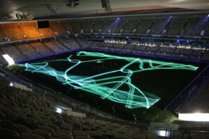 Europe Évènement - Photo of a stadium with projection of green laser shapes on it
